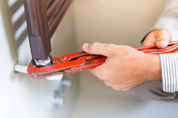 istock Plumber fixing a radiator, construction and architecture concepts 886978114