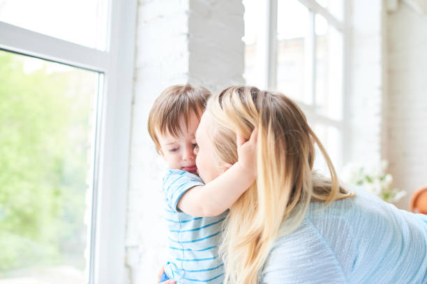 istock Loving mom kissing son 886994784