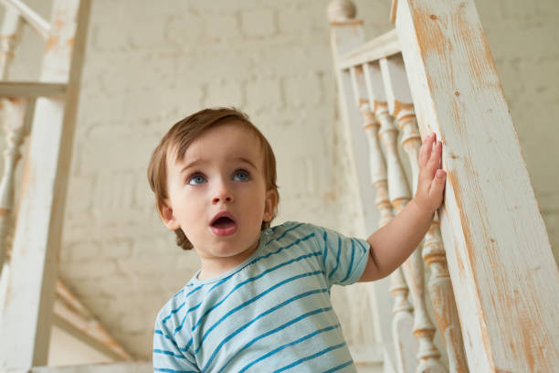 istock Pensive curious toddler on staircase 886994838