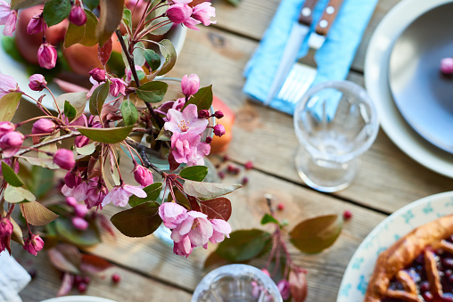 Focus on pink blossom twig decorating celebratory table for party