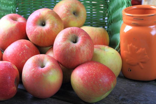 istock Fresh red apples on wooden table 887027660