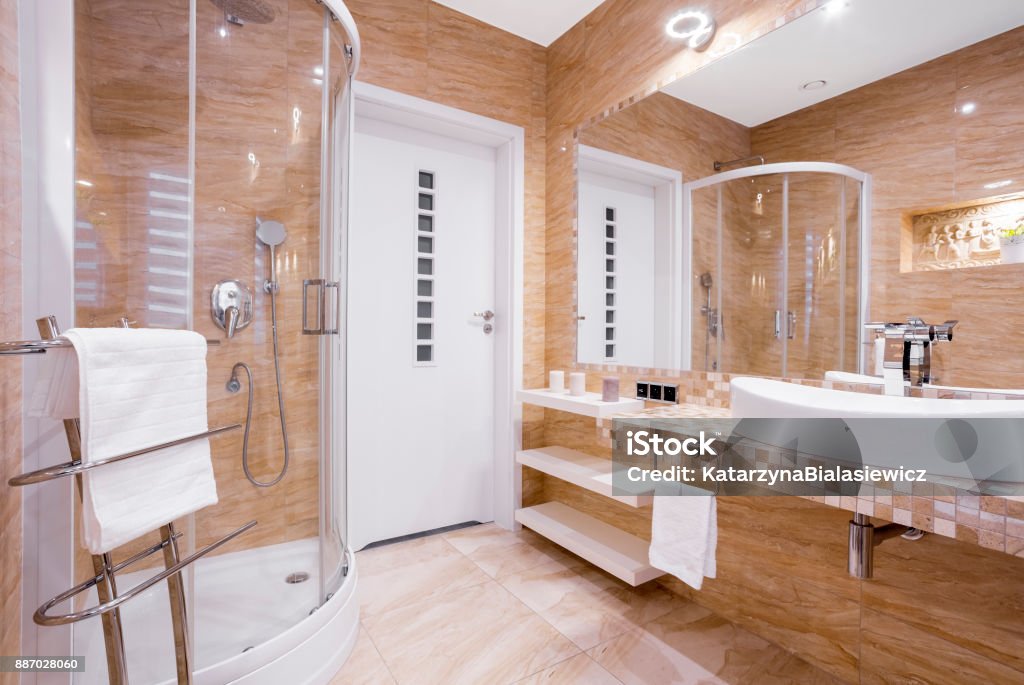 Beige bathroom with shower Beige fancy bathroom with shower and sandstone tiles Shower Stock Photo