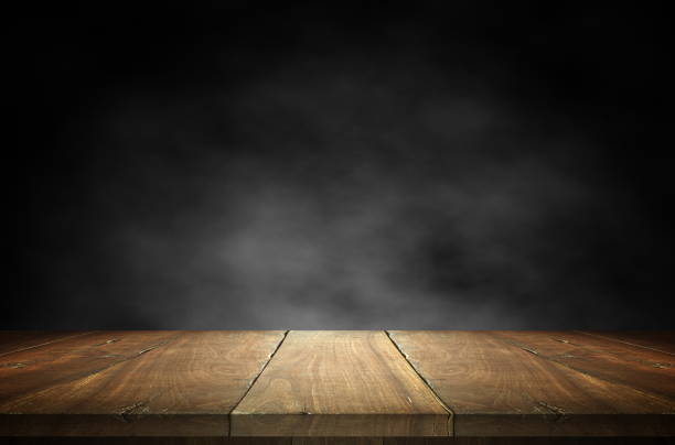 istock Old wood table top with smoke in the dark background. 887031042