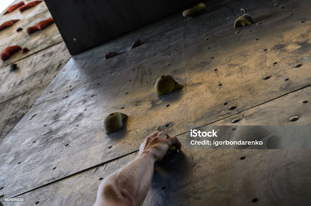 Hand of the young man on a hook of the artificial climbing wall Hand of young man on a hook of the artificial climbing wall Active Lifestyle Stock Photo