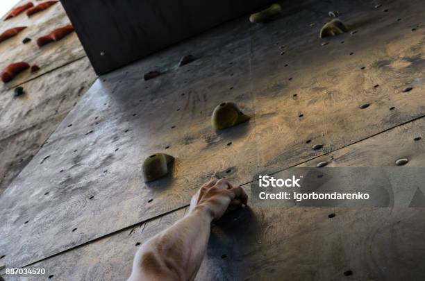 Hand Of The Young Man On A Hook Of The Artificial Climbing Wall Stock Photo - Download Image Now