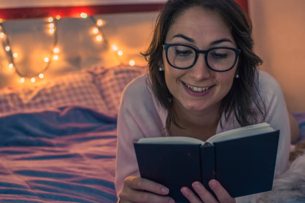 istock Girl reading on bed 887034680
