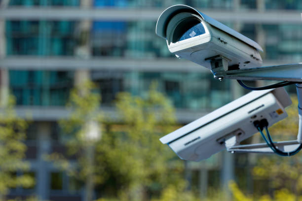 istock cctv security camera in a city with blury business building on background 887034856