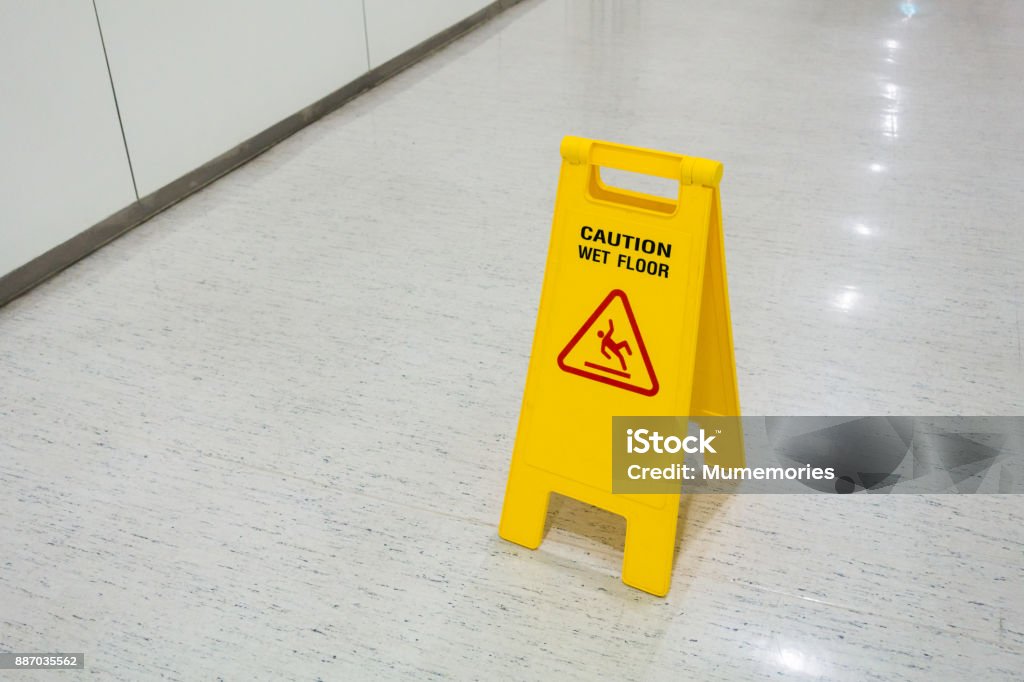 Signs plastic yellow put on floor text caution wet floor Signs plastic yellow put on floor text caution wet floor in hospital Building Story Stock Photo