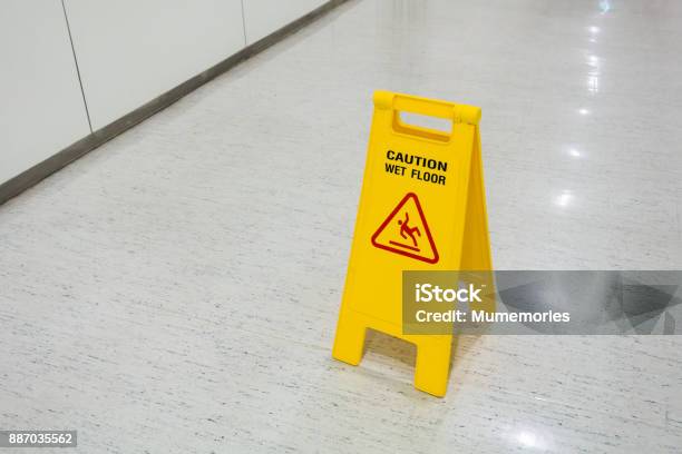 Signs Plastic Yellow Put On Floor Text Caution Wet Floor Stock Photo - Download Image Now