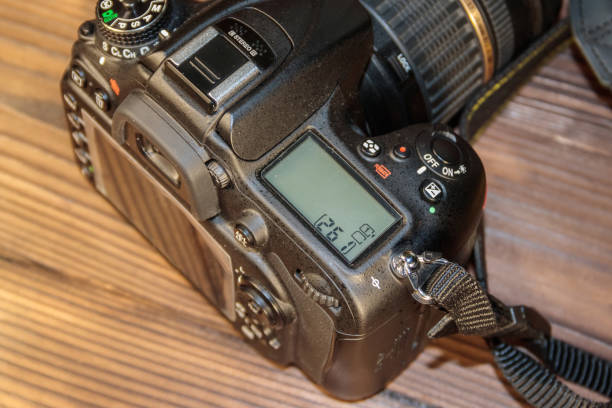 istock Professional digital photo camera on wooden background close-up 887037902