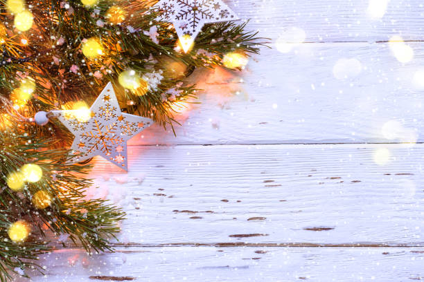 istock Christmas snowy background. Fir branches with burning garland 887047552