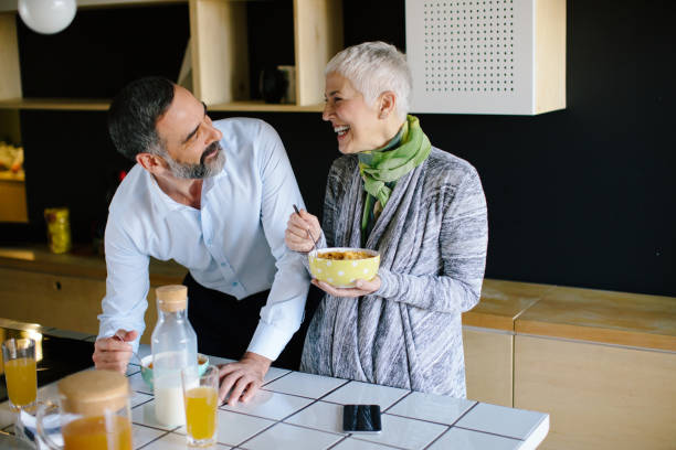 istock Senior couple in kitchen having breakfast and talking 887072208