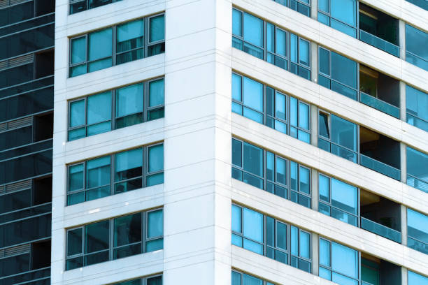 istock Windows of an apartment tower with balconies 887083184