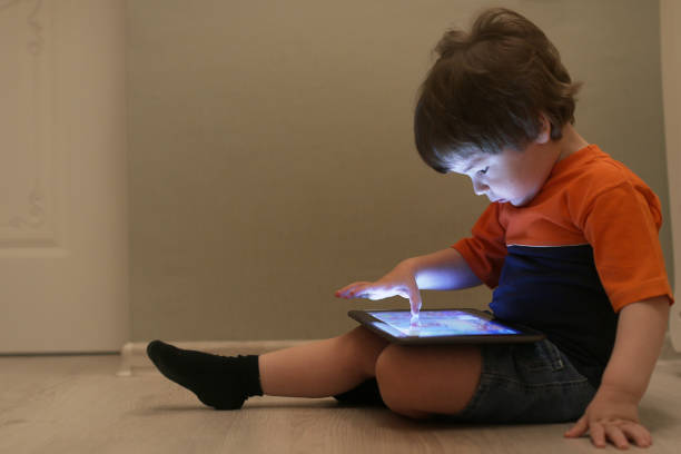 istock Young kid playing on a floor in a room 887091466