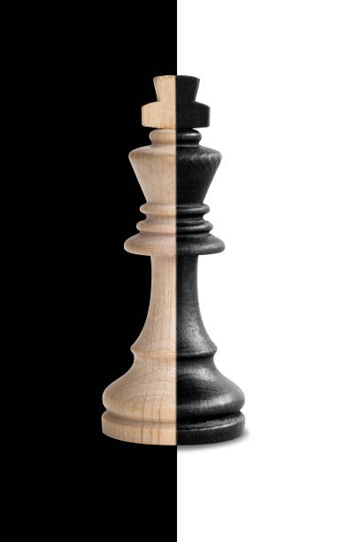 istock Chess king showing its duality in black and white background 887100648