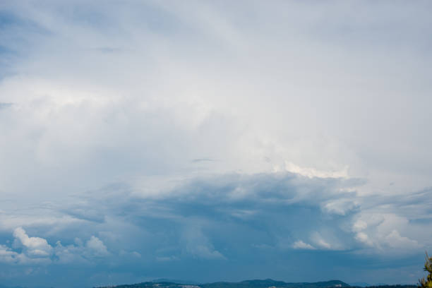 istock Beautifuly clear blue sky with layers of white clouds flying by 887100748