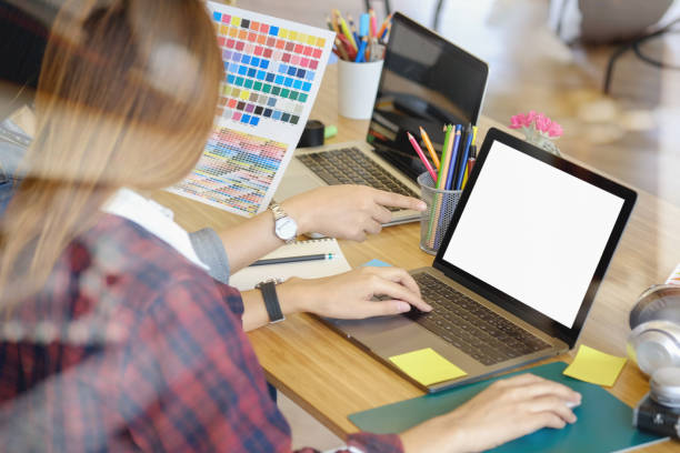 istock Professional employees discussing ideas of project on laptop 887103610