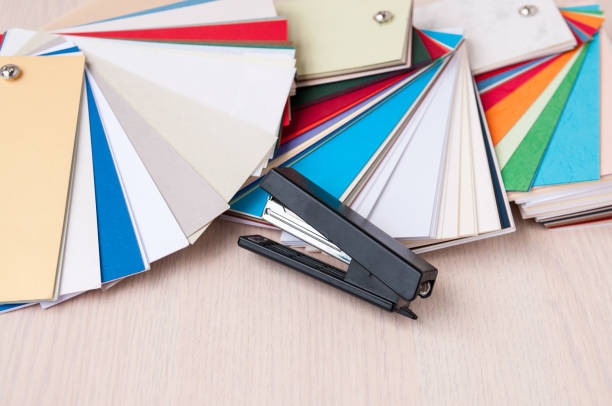 istock Set of designer paper and a black stapler on the table 887103728