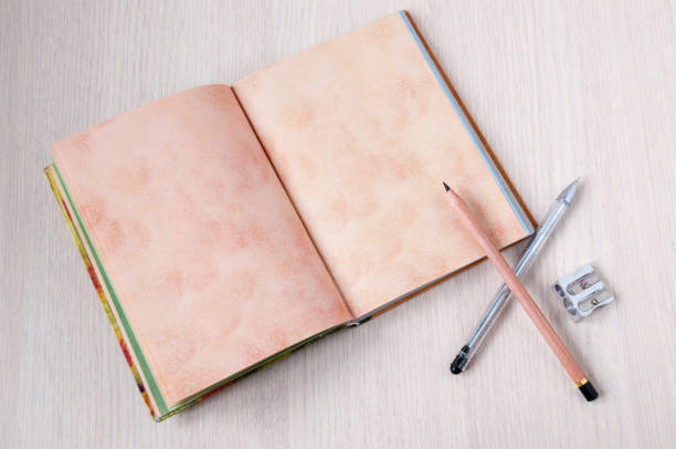 istock Open book on the table, pen and pencil 887106822