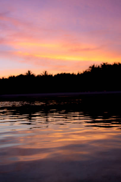 istock Tropical Sunset and island silhouette 887109332