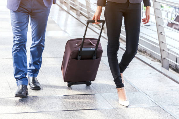 istock Business people walking with luggage 887127236