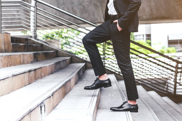 istock Businessman walking up the stairs 887133454