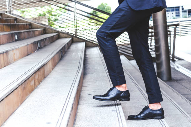 istock Businessman walking up the stairs 887133458