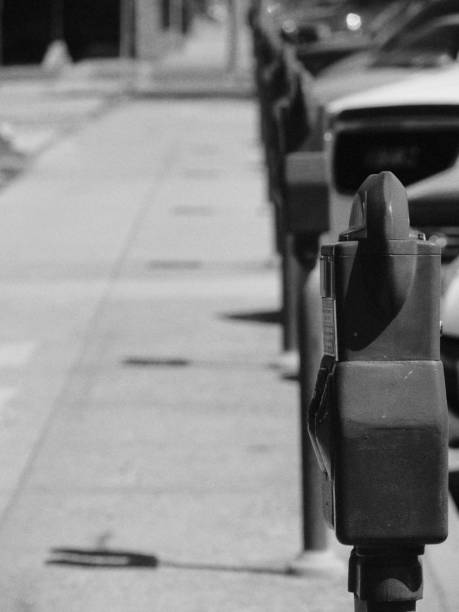 istock a row of parking meters along a sidewalk 887143848