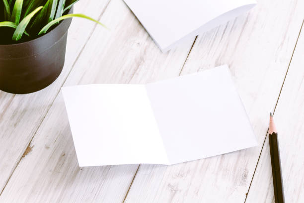istock White blank paper magazine mockup on wooden table 887144012
