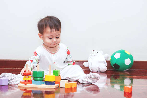 istock Baby boy playing with wooden blocks 887144076