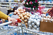 Shopper with shopping cart on Christmas sale in shop