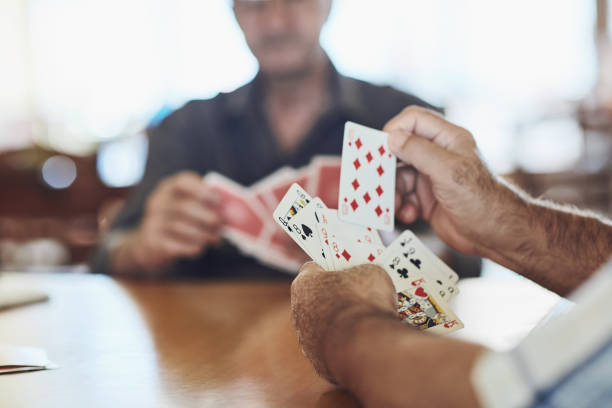 I can do something with this hand! Cropped shot of seniors playing poker in their retirement home poker card game photos stock pictures, royalty-free photos & images