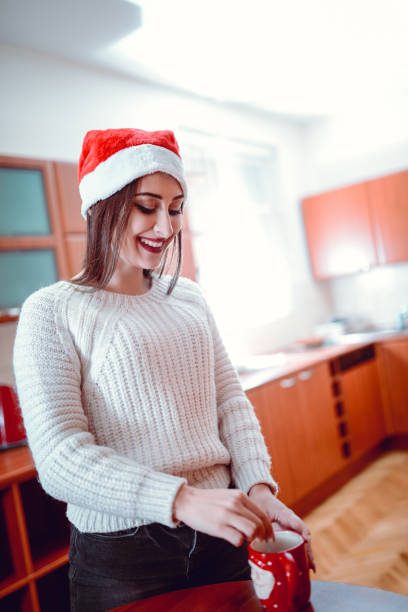 istock Cute Smiling Female Preparing Hot Drink in the Kitchen 887156064