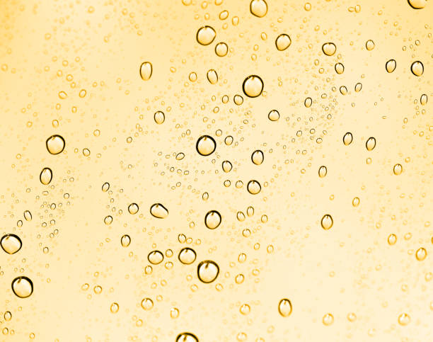 istock golden water drops on glass 887158832