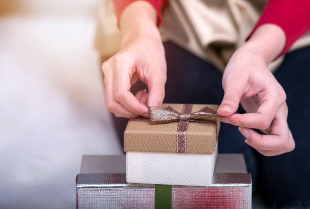 istock woman hands opening gift box 887167152