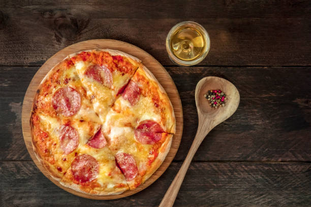 istock Pepperoni pizza with white wine, peppercorns, and copyspace 887192722