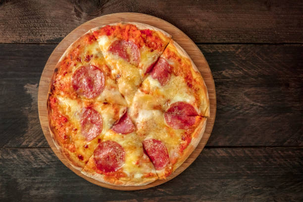 istock Cut pepperoni pizza with place for text, overhead shot 887192784