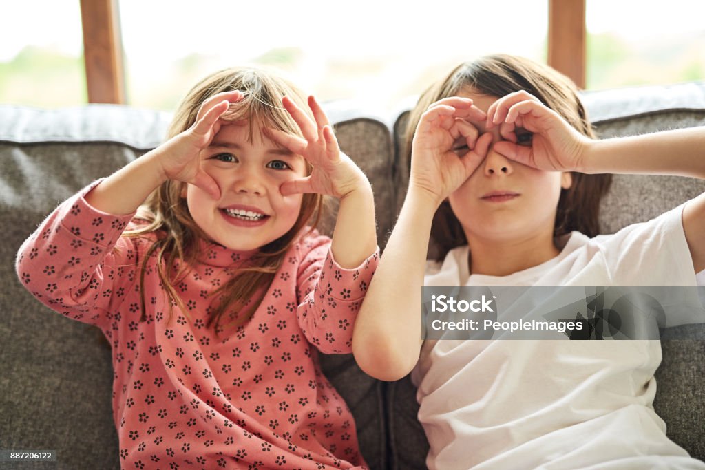 We see you! Portrait of two adorable little siblings bonding together at home Eye Stock Photo