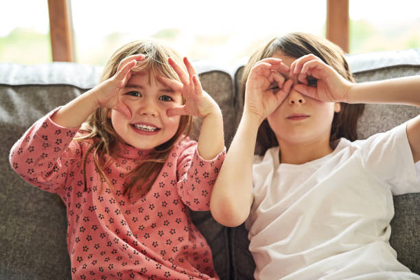 We see you! Portrait of two adorable little siblings bonding together at home sister photos stock pictures, royalty-free photos & images