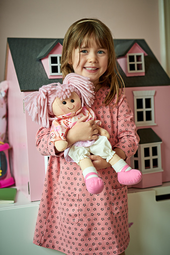 Portrait of an adorable little girl playing with her toys at home