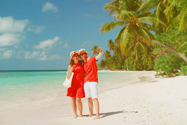 istock Young happy couple making a selfie on beach 887206628