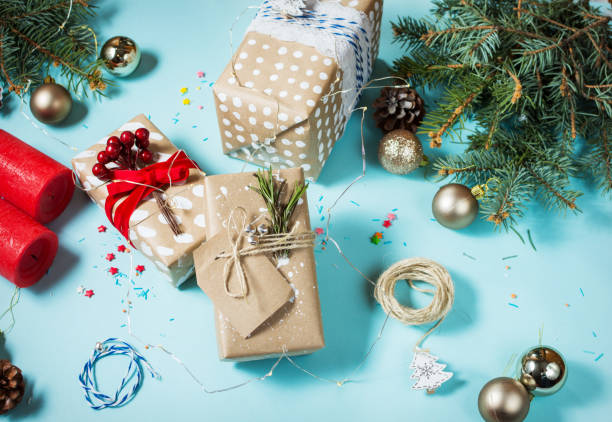 istock Christmas background with decorations and gift boxes on blue board 887208926