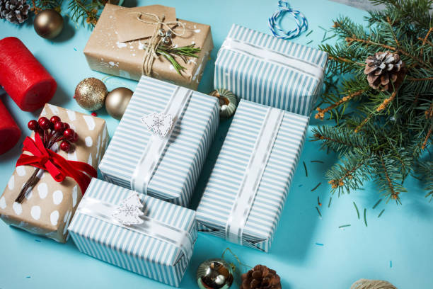 istock Christmas background with decorations and gift boxes on blue board 887208972