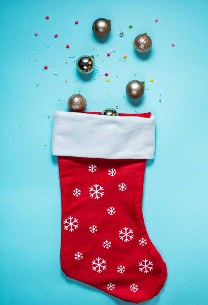 istock Ice Cream Cone with Christmas sock on blue background. Flat Lay. 887209664