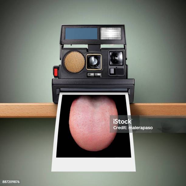 Instant Camera Sticking Out Tongue Stock Photo - Download Image Now - 1970-1979, 1980-1989, Bizarre