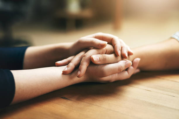 Small gestures of kindness go a long way Closeup shot of two unidentifiable people holding hands in comfort grief stock pictures, royalty-free photos & images