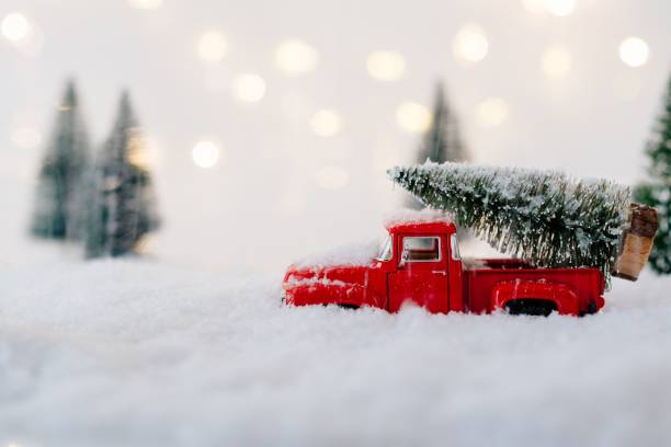 istock Red toy car carrying Christmas tree. 887227118