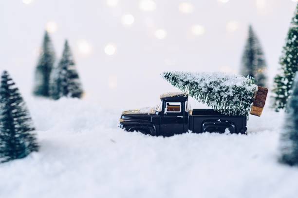 istock Black toy car carrying Christmas tree. 887227244