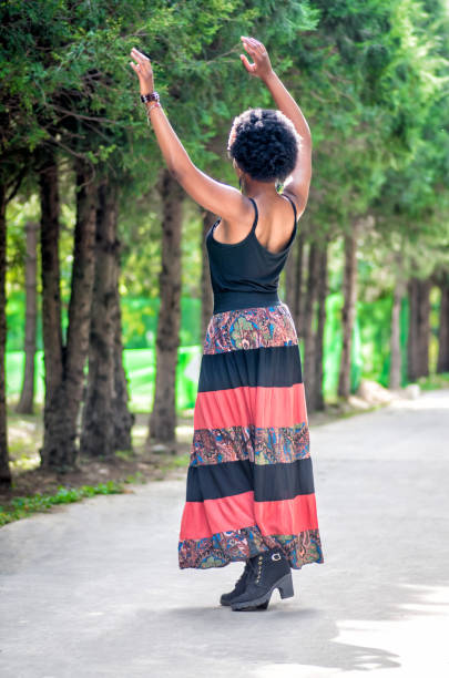 istock african girl is dancing on the meadow 887228052