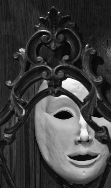 reflection of a plain venetian mask on an antique venetian mirror - mirror reflection mystery frame imagens e fotografias de stock